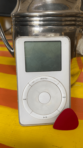 original 5G iPod photo leaning against silver pitcher